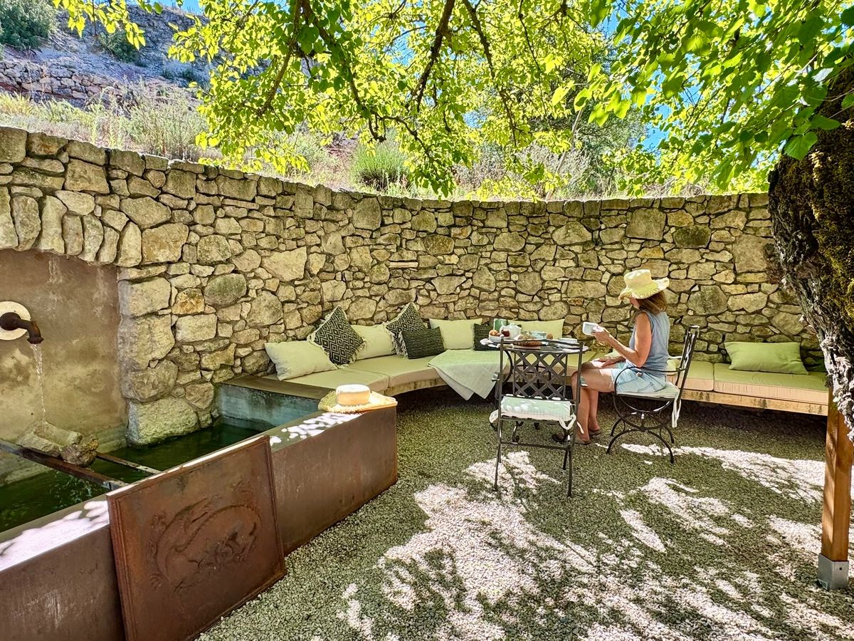 Breakfast in the courtyard, on the bench along the dry-stone wall, in the shade of the mulberry tree.